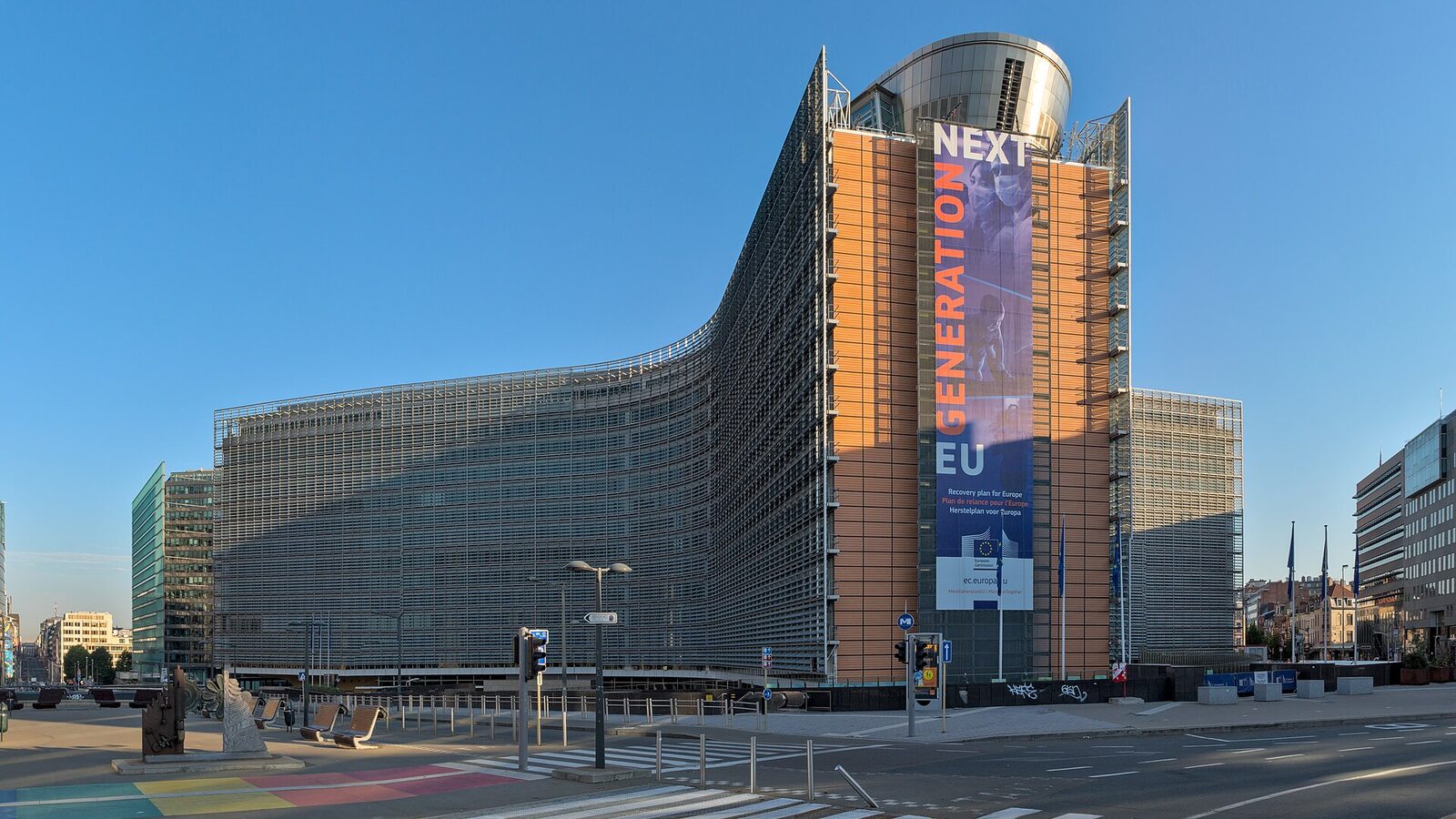 The curved glass and steel Berlaymont building, headquarters of the European Commission in Brussels, under a clear blue sky