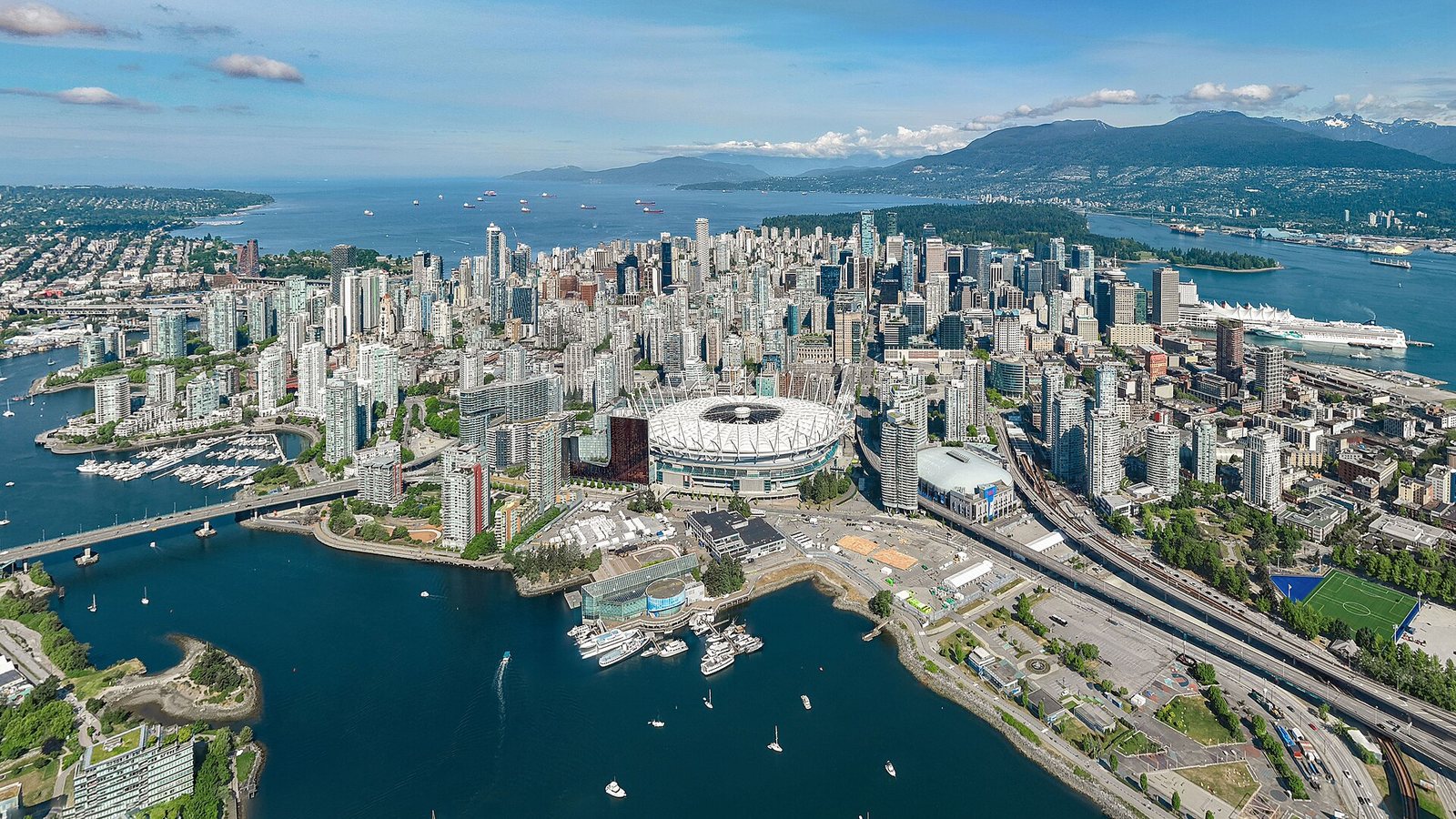 Aerial view of downtown Vancouver with False Creek, the stadium and the North Shore mountains