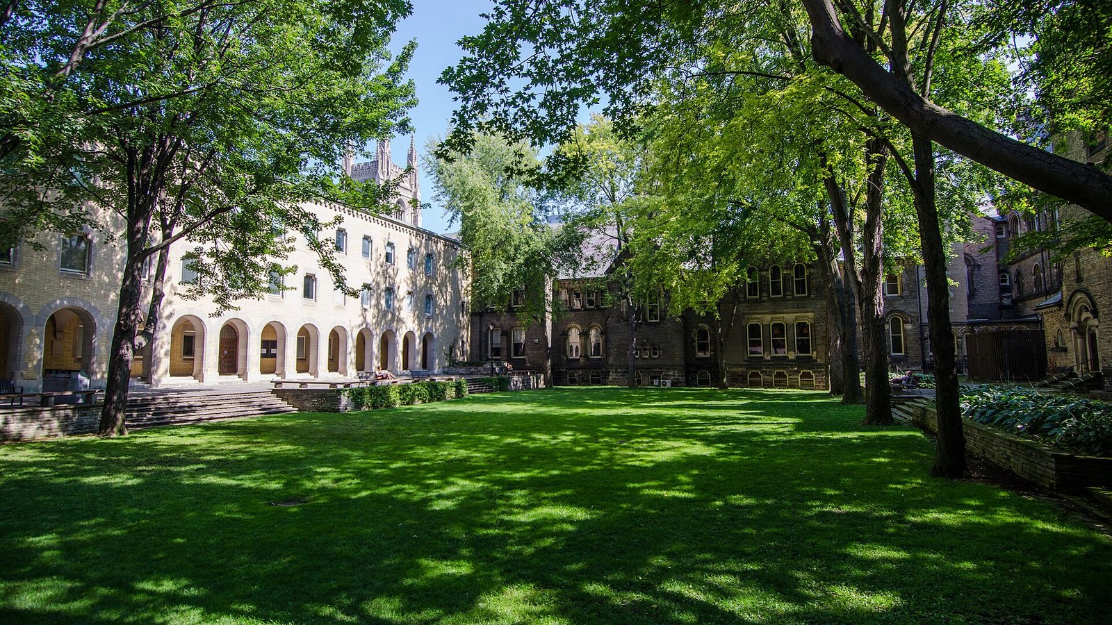 The tree-shaded courtyard of University College at the University of Toronto