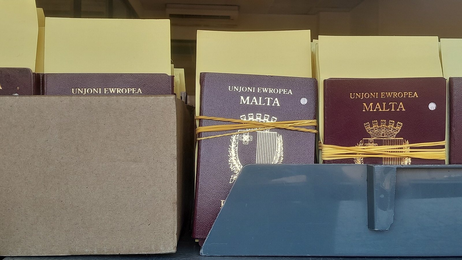 Maltese EU passports bundled and waiting for collection at a passport office