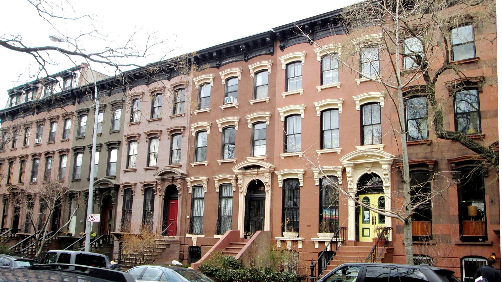 A row of brownstone houses with stoops on a residential street in Prospect Heights, Brooklyn
