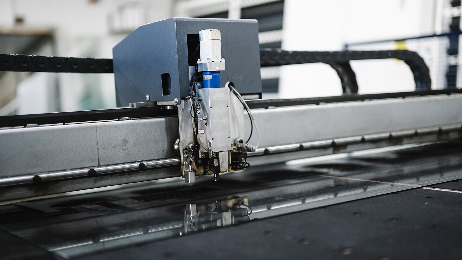 An automated cutting machine at work on a factory production line
