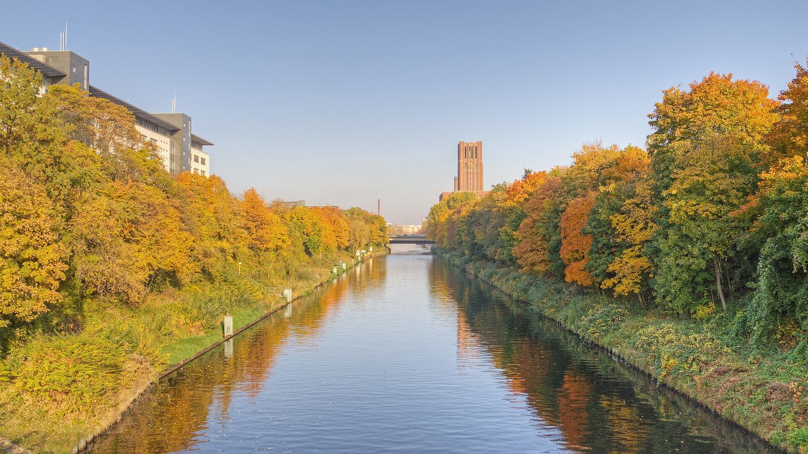 Berlin-Tempelhof. Teltow Canal during Indian summer. In the background, the clock tower of the Ullstein House is visible