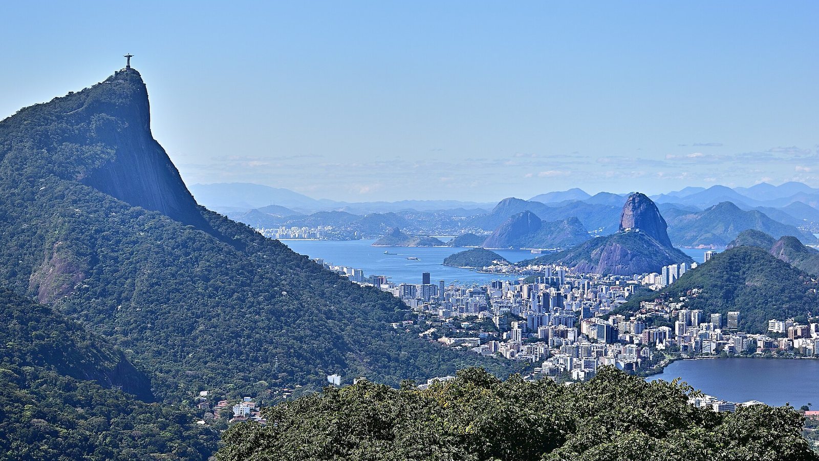 View over Rio de Janeiro with Corcovado on the left, Sugarloaf Mountain and the bay under a clear sky
