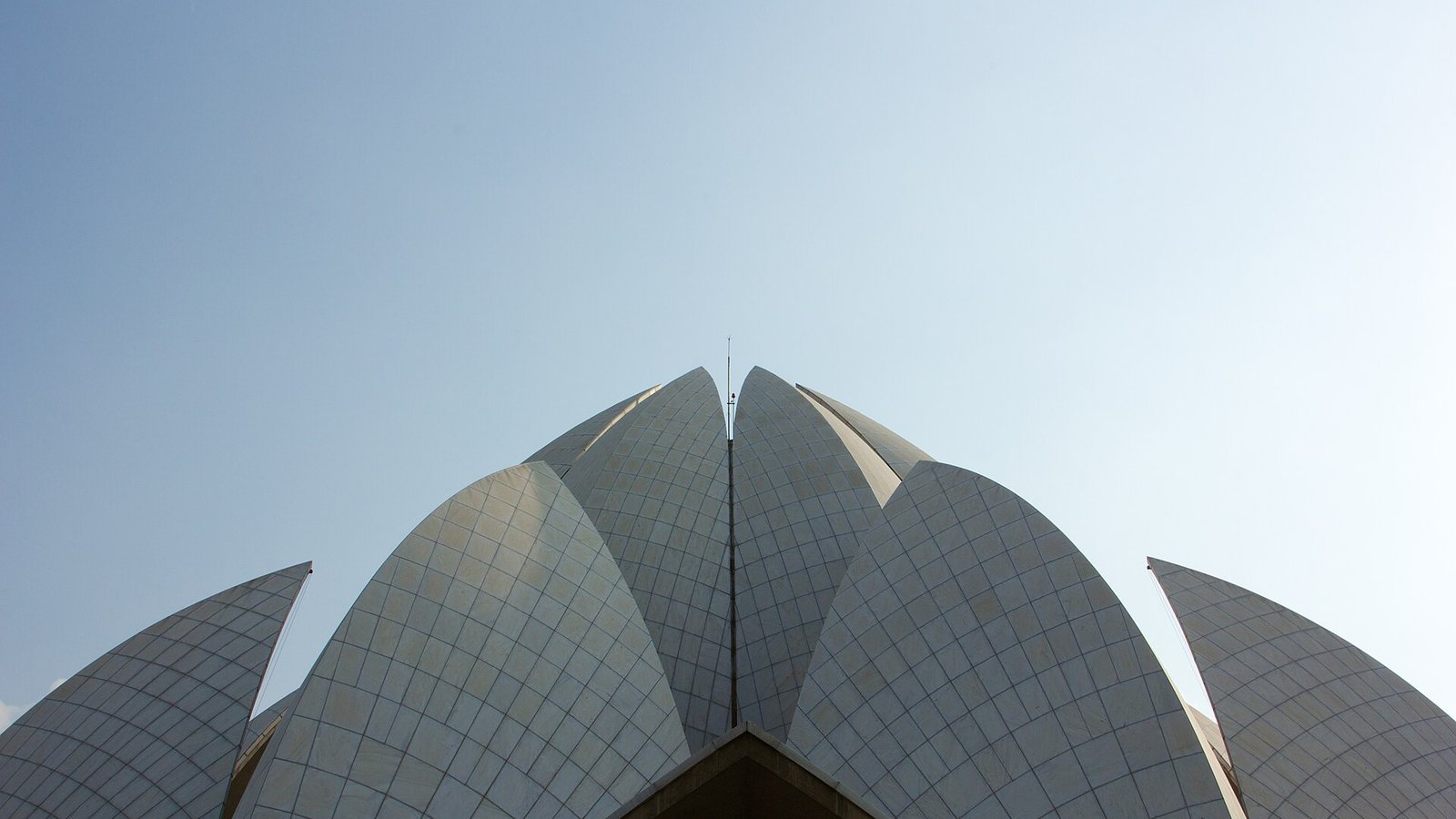 White marble petals of the Lotus Temple in New Delhi against a clear sky