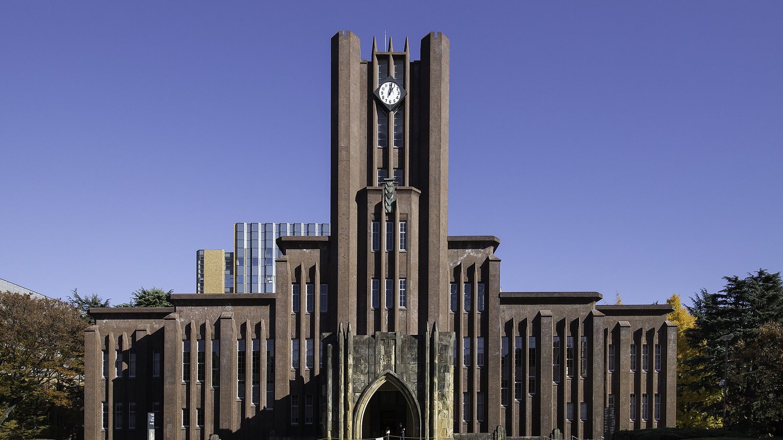 The brick clock tower of Yasuda Auditorium at the University of Tokyo under a clear sky