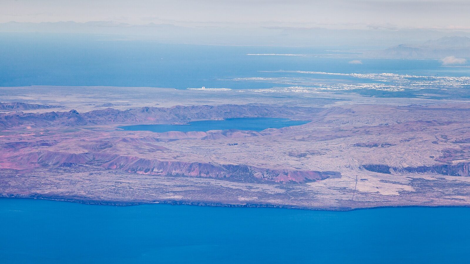 Aerial view of the southwest of Iceland, with the Atlantic coast, Lake Kleifarvatn among volcanic hills and Reykjavík on the far shore
