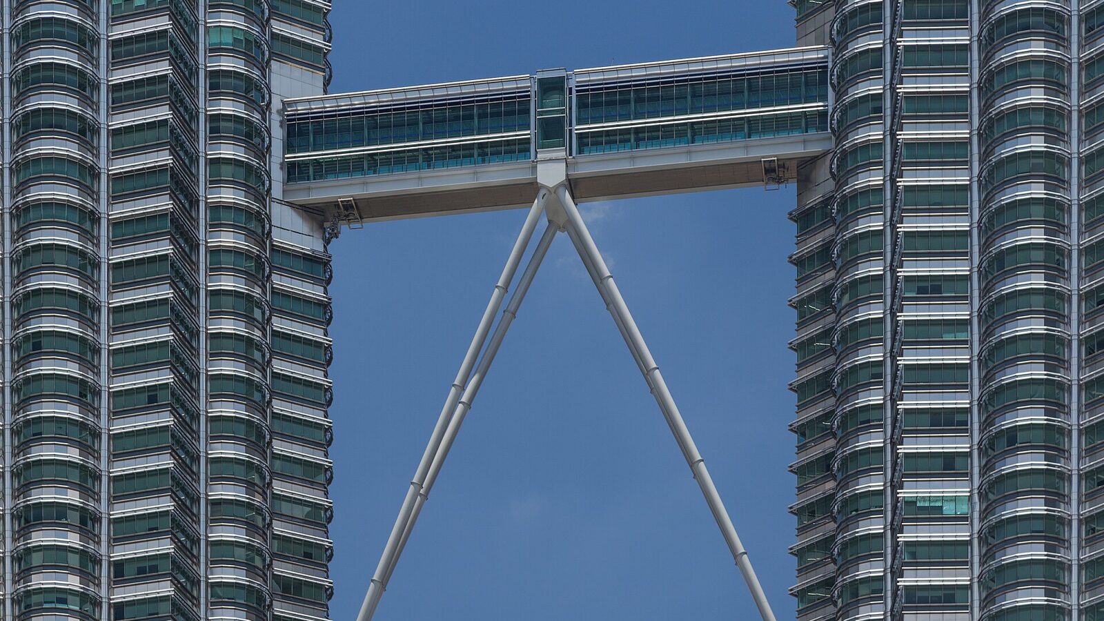 The skybridge connecting the Petronas Towers in Kuala Lumpur against a blue sky