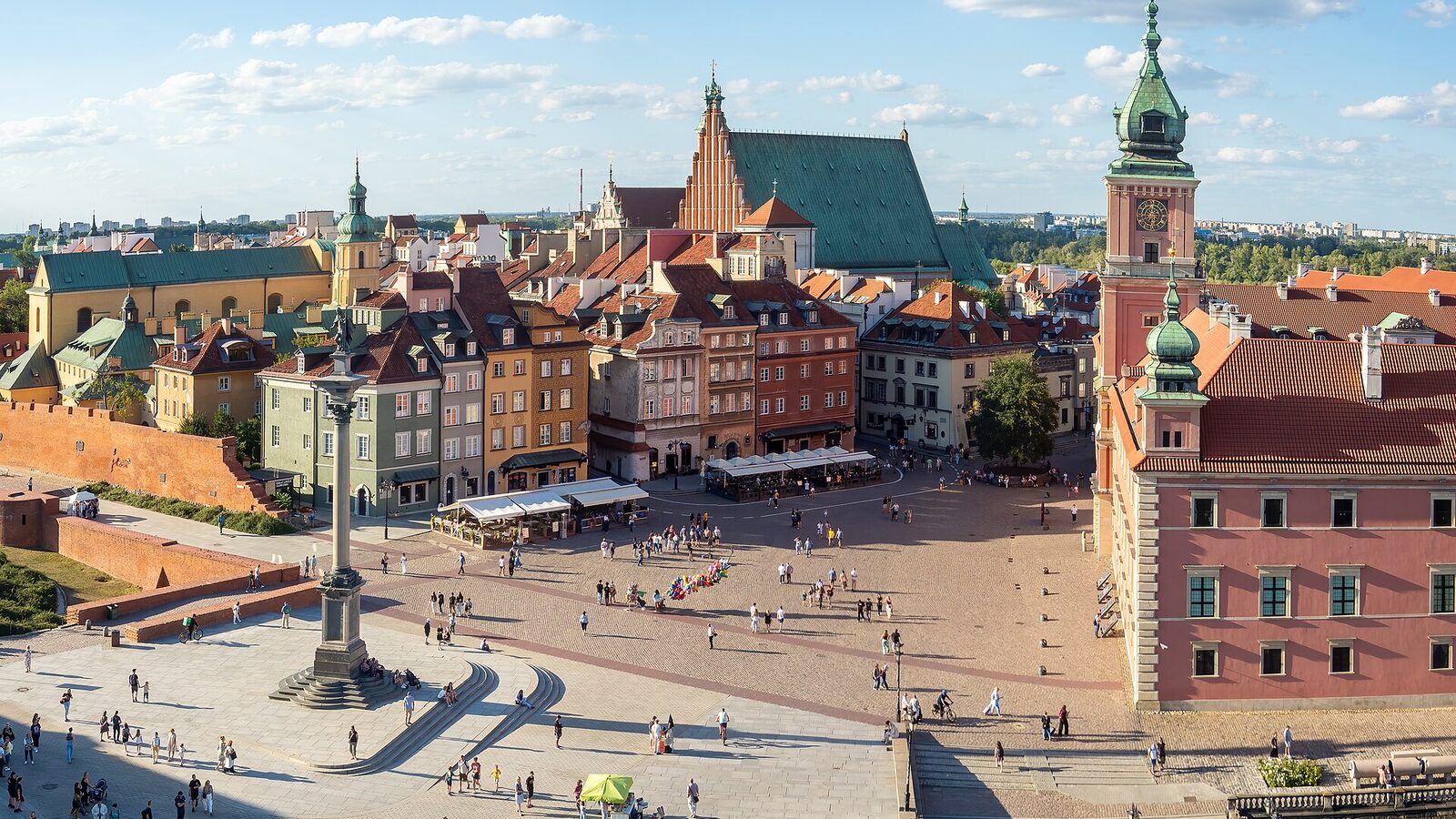 Castle Square in Warsaw with Sigismund's Column, the Royal Castle and colourful Old Town houses under a blue sky
