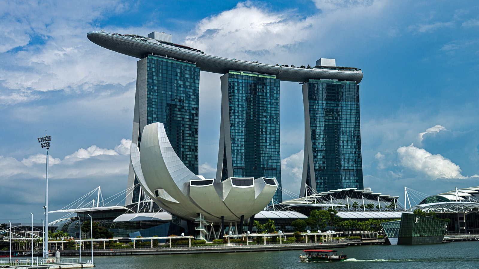 Marina Bay Sands hotel and the ArtScience Museum in Singapore under a blue sky