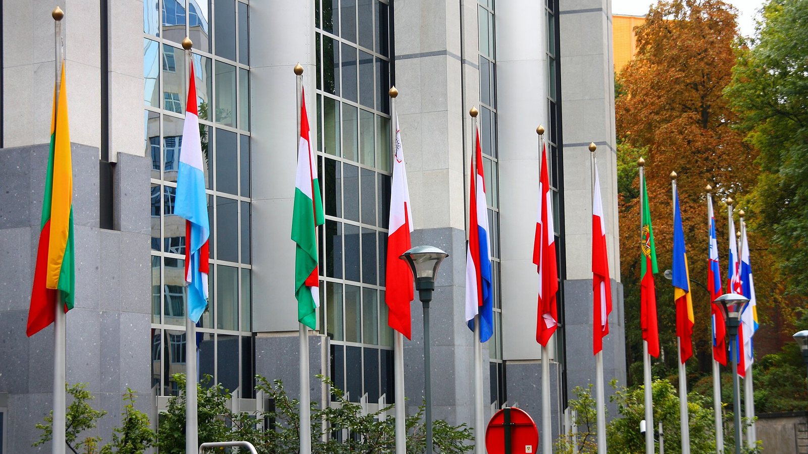 Flags of EU member states in front of the European Parliament in Brussels