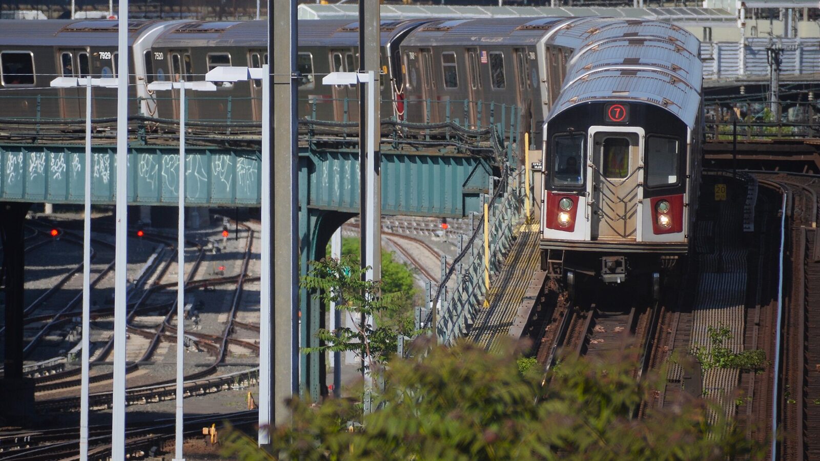 Manhattan-bound 7 train heading underground into the Hunters Point Ave station