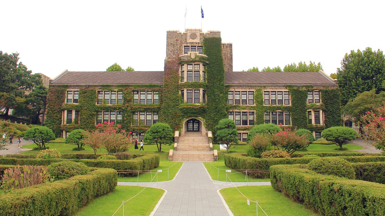 Ivy-covered Underwood Hall at Yonsei University in Seoul with a formal garden in front