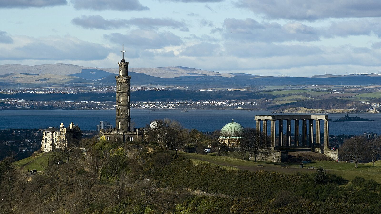 Calton Hill in Edinburgh with the Nelson Monument and National Monument above the Firth of Forth