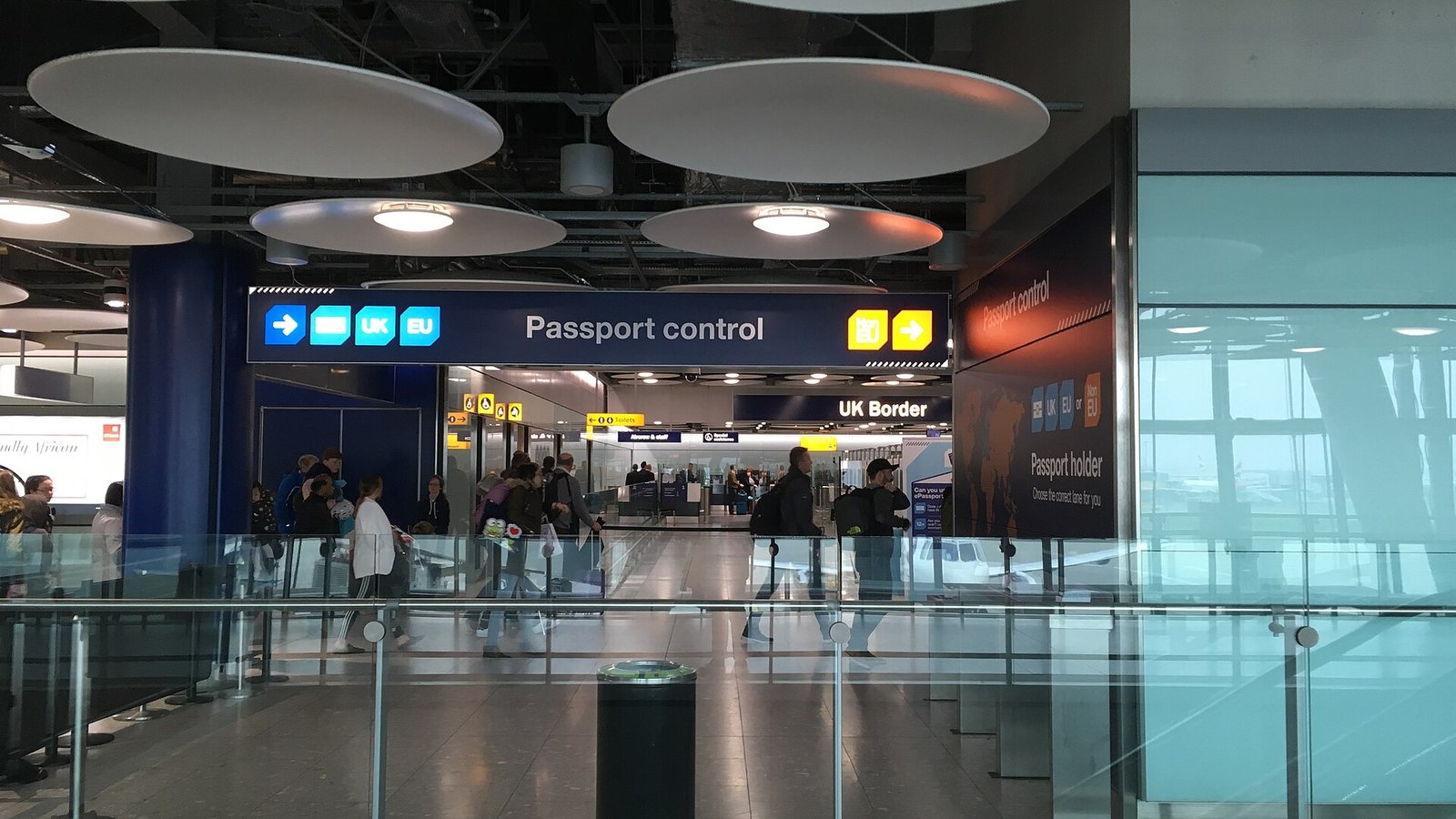 Passport control signs for the UK Border at London Heathrow Airport