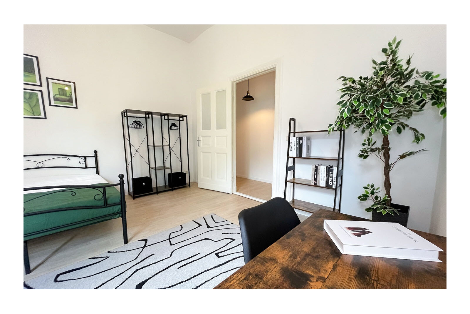 Furnished room with bed, desk and rug